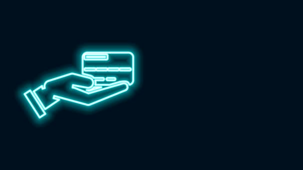 Glödande neon line Mänsklig hand med kreditkort ikon isolerad på svart bakgrund. Betalning online. Betala med kort. Finansiella transaktioner. 4K Video motion grafisk animation — Stockvideo