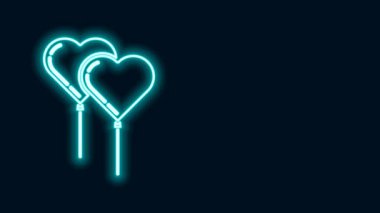 Siyah zemin üzerinde izole edilmiş kurdele ikonu olan kalp şeklinde parlayan neon çizgili balonlar. 4K Video hareketli grafik canlandırması