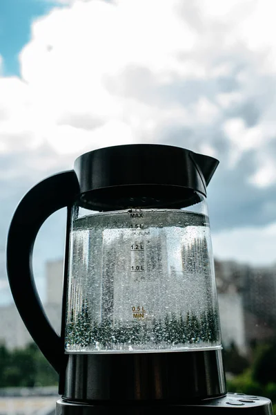 boiling water in glass kettle