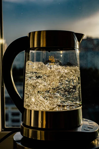 boiling water in glass kettle