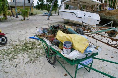 Bir plajda bir çöp, mercan temizleme girişimi, Maafushi, Maldivler.