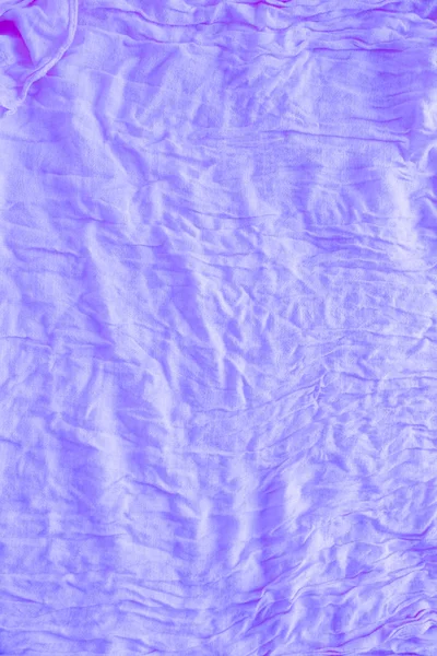 Soft violet colored creased fabric texture abstract background