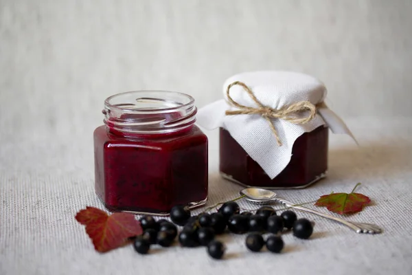 Black currant jam in glass jars — Stock Photo, Image