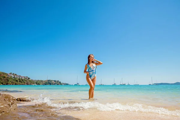 Kobieta w stojący niebieski strój kąpielowy w morzu — Zdjęcie stockowe
