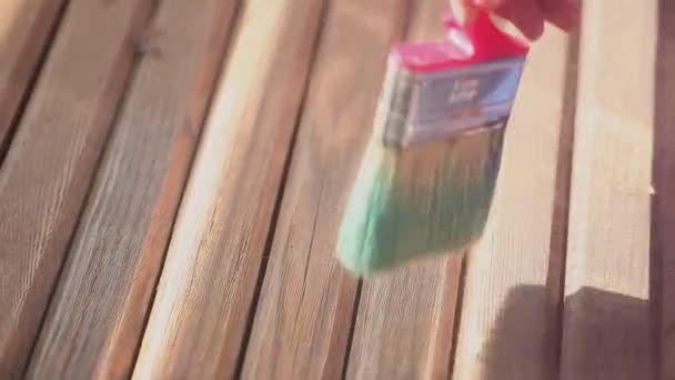 Close-up woman hand whisk dust from wood batten board — Stock Video