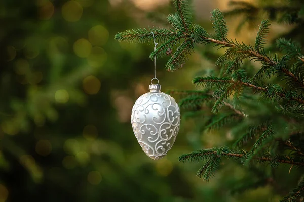 Witte ornament kerst decoratie speelgoed opknoping op een sparren tak met bokeh — Stockfoto