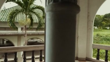 Sırt çantalı gezgin terk edilmiş binanın balkonunda duruyor.