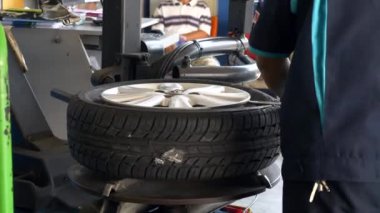 Özel Ekipman ve Değiştirme Lastiği ile Tekerleği Otomobil Tekerleğinden Çıkaran Adam