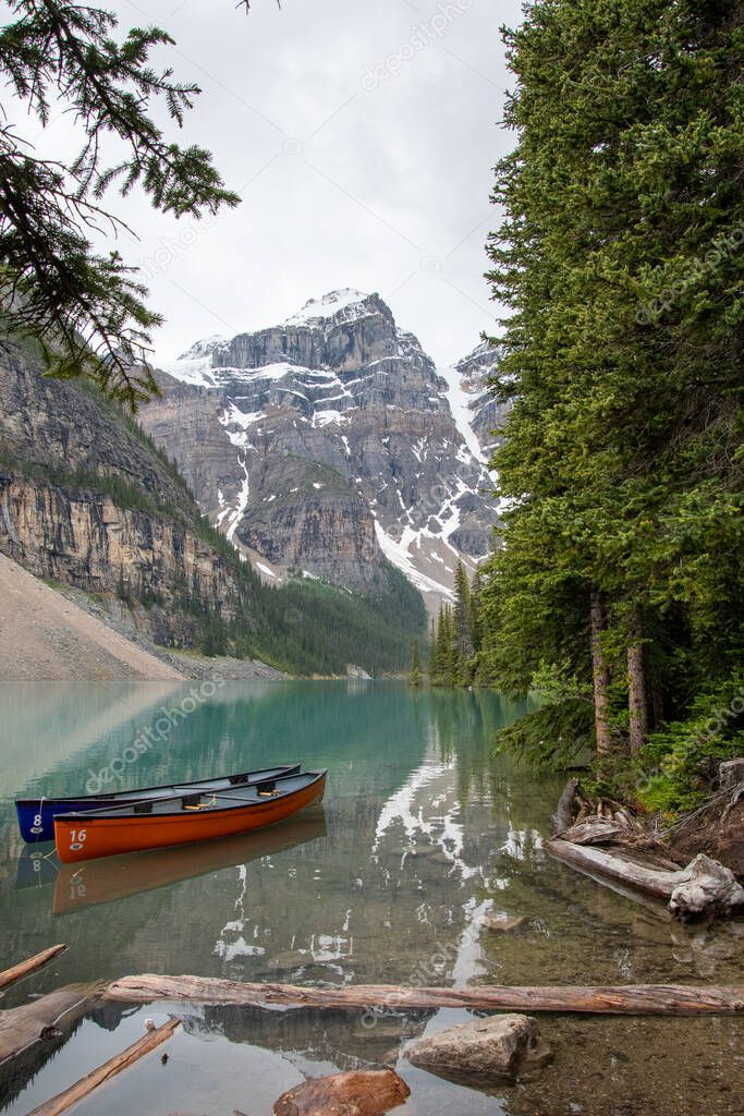 A picture of Moraine lake and ten peaks with boats. AB Canada