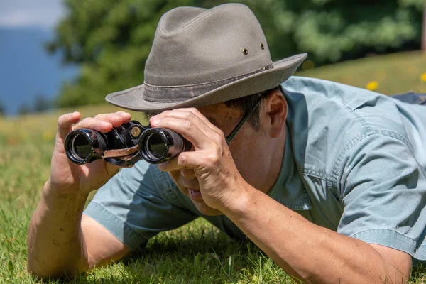 Side View Man Lying Grass Field Using Binoculars Vancouver Canada — Stock Photo, Image