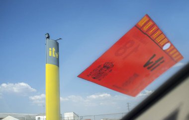 Badajoz, Spain - 19th june, 2018: Inspection Station Pole Sign with sticker in Spain. View from the inside of the car clipart