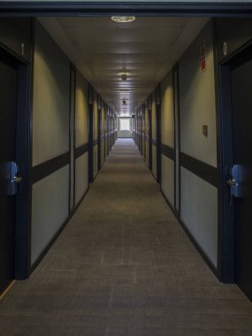 Doğal ışıkla aydınlatılmış koyu Otel koridor. Geniş bir pencere arka planda görülebilir