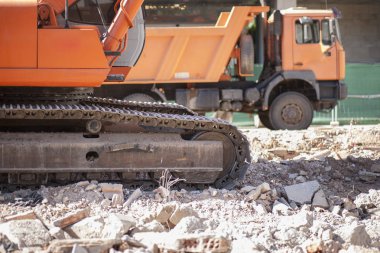Tuğla moloz moloz yükler üzerinde arketör ve damperli kamyon izleyin. Şantiye