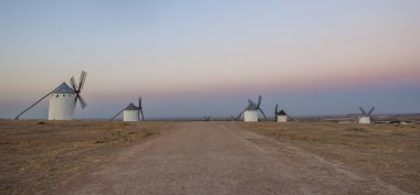 Traditional windmills at rising, Campo de Criptana, La Mancha, Spain. Panoramic clipart