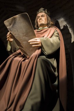 Cordoba, Spain - 2018, Sept 8th: Life-sized sculpture of Alfonso X of Castile, the Wise. Calahorra Tower Museum, Cordoba, Spain clipart
