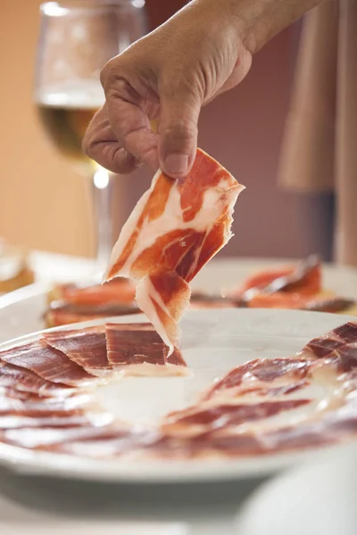 Hand Taking Iberian Cured Ham Slice Plate Selective Focus Point — Stock Photo, Image