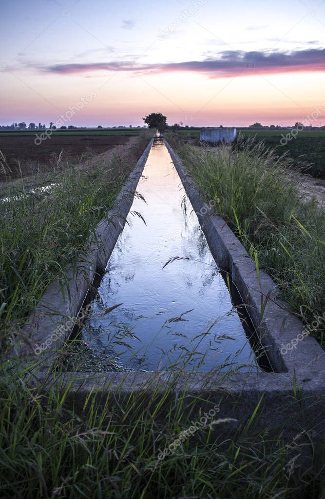 Concrete irrigation canal at sunset. Low Guadiana Lands, Extremadura, Spain