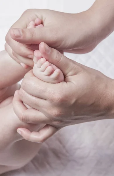 Feet massage to 3 month baby boy. thumb-over-thumb motion from heel to toes.