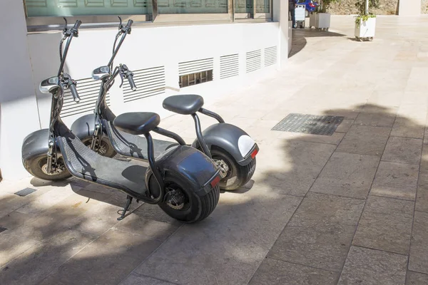 Electric urban vehicles type mobility scooter for rent. Two units parked