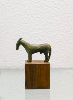 Seville, Spain - July 7th, 2018: Horse-shaped bronze votive offering from iberian sanctuary, 4th Century BCE, at Archaeological Museum of Seville, Andalusia, Spain clipart