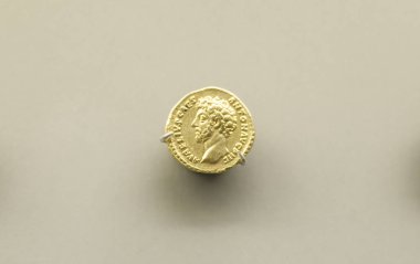 Merida, Spain - August 25th, 2018: Gold coin of Marcus Aurelius Roman Emperor at National Museum of Roman Art in Merida, Spain clipart