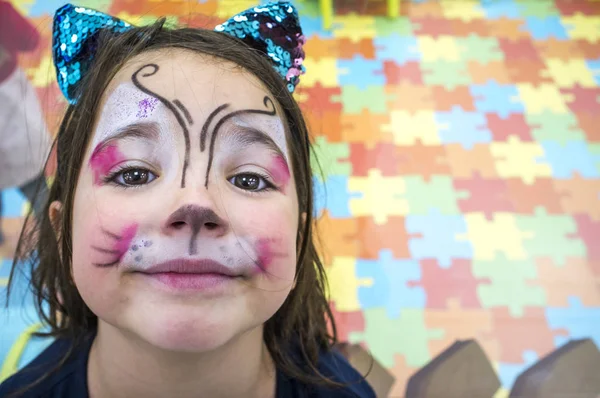 Child girl posing face painted during at Children Playroom. High angle shot