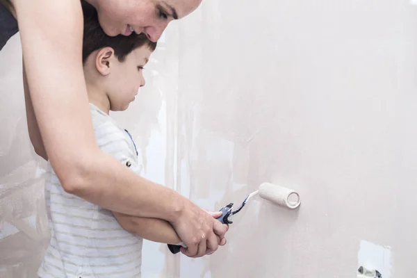 Мама учит ее 3 года сын живописи с роликом на дому — стоковое фото