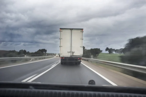 Driving behind slow truck on local road a rainy day — Stock Photo, Image