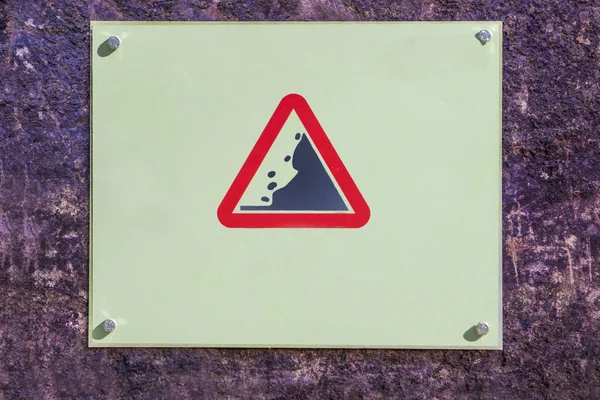 Landslide Caution falling rocks sign attached to the rock — Stock Photo, Image