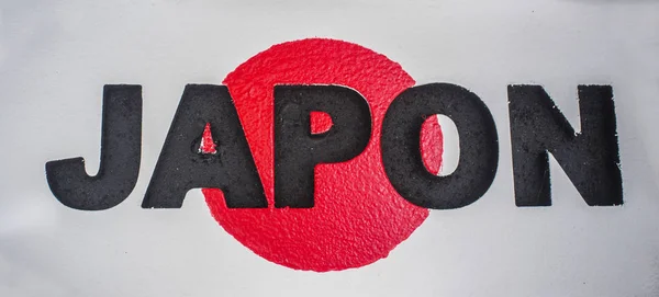 Assinar com o nome do Japão e bandeira como fundo — Fotografia de Stock