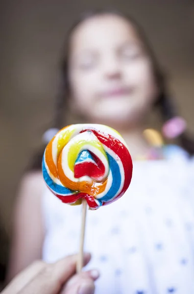 Child girl with colorful big lollipop — Stock Photo, Image