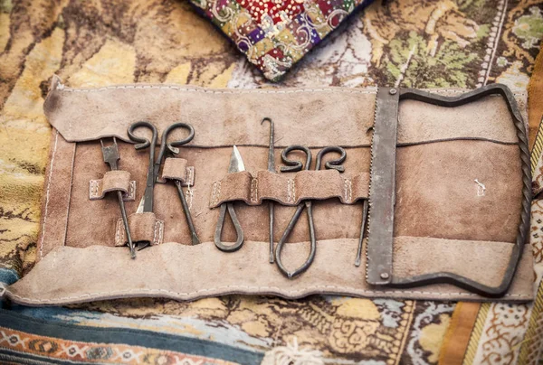 Medieval surgery doctors tools in leather wrap — Stock Photo, Image