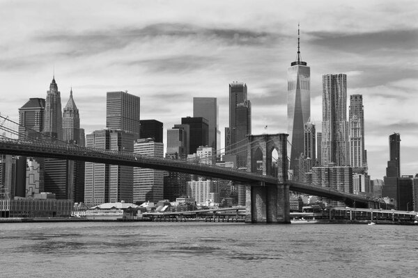A view to the lower Manhattan through the Brooklyn bridge in New York.
