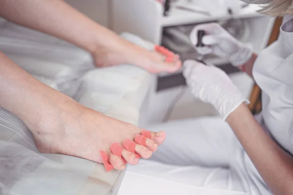 Pedicurist Robi Biały Lakier Paznokci Nogach Klienta Pomocą Separatora Palców — Zdjęcie stockowe