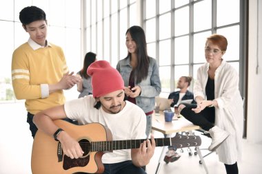 Rahatlatıcı, gitar çalmak ve mola sırasında ofiste sohbet iş kişilerdir