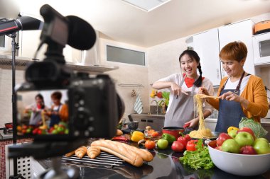 Anne ve kız blogger vlogger ve çevrimiçi etkileyicisi sağlıklı yiyecekler üzerine video içeriği kaydediyor