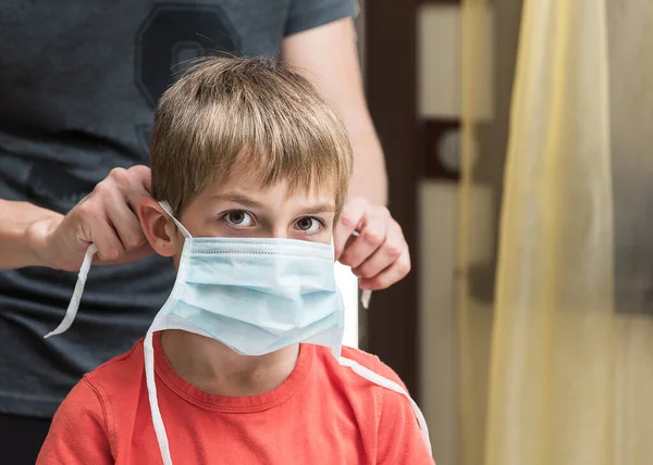 Kid with medical face mask, adult wearing face mask on child.