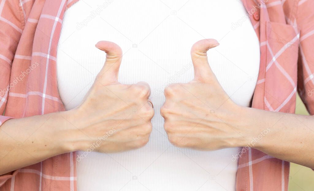 woman showing thumb up. hand with hyper flexible thumbs