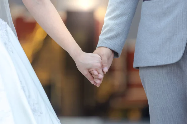 Bride and bridegroom married hands when sun is falling. background.Soft color focus