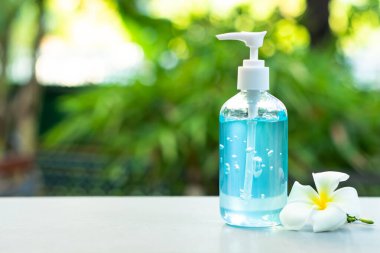 Alkol jeli şişesi ya da antibakteri ve virüs için el dezenfektanları. Doğal ışığın bulanık arka planında ve rahat görünmesi için boş alanda..