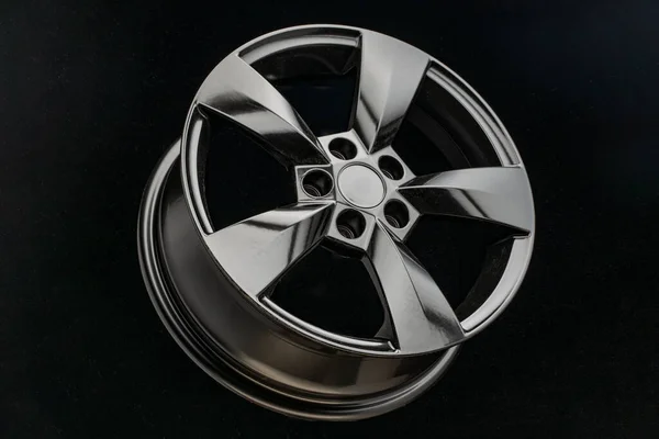 black matte alloy wheel on a dark background. trade in auto parts.