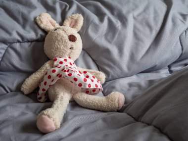 Rabbit doll that was stripped of clothes, statutory rape concept clipart