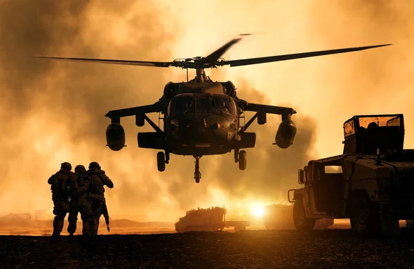 2 soldiers helping wounded soldier between dust in battle field to board the helicopter