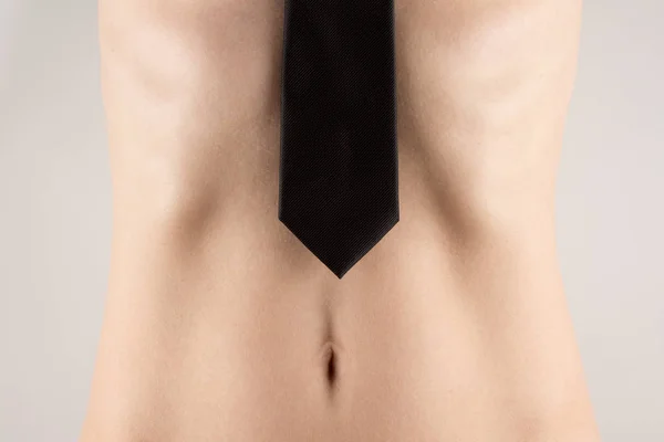 Naked girl covered man black tie turning front view with the beautiful navel — Stock Photo, Image