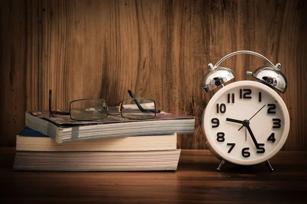 White alarm clock on wooden old background — Stock Photo, Image