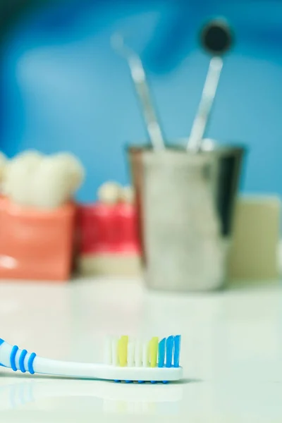 Toothbrush with dental instruments — Stock Photo, Image