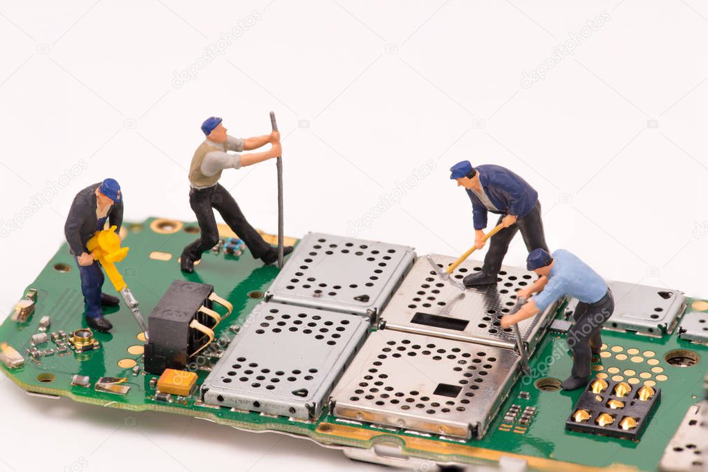 miniature people repair electronic device