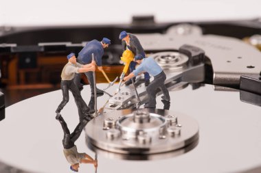 technicial team miniature people repairing  hard drive. Figures  clipart