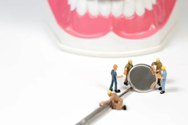 Pessoas e ferramenta dentária em fundo branco, em miniatura — Fotografia de Stock