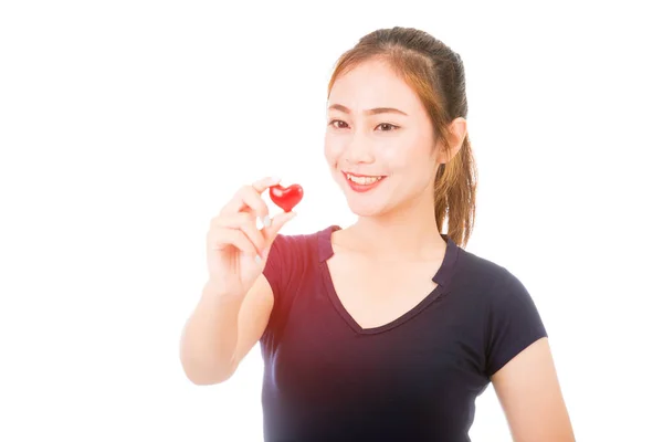 Símbolo rojo del corazón en mano femenina — Foto de Stock